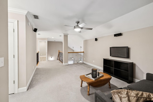 living room featuring vaulted ceiling, ornamental molding, ceiling fan, and light carpet