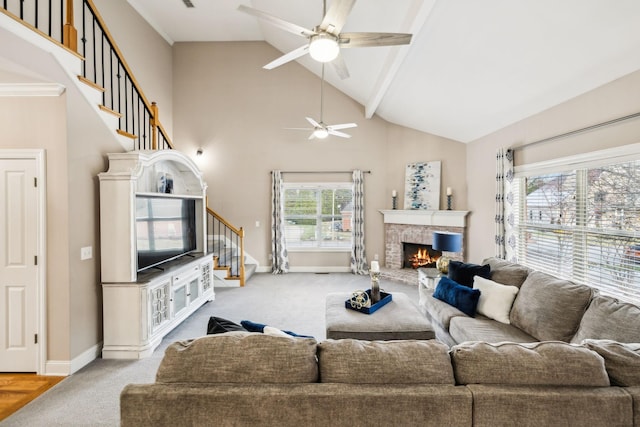 carpeted living room featuring a fireplace, high vaulted ceiling, beam ceiling, and ceiling fan