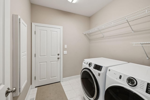 laundry area with light tile patterned flooring and independent washer and dryer