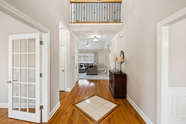 hallway featuring wood-type flooring and ornamental molding