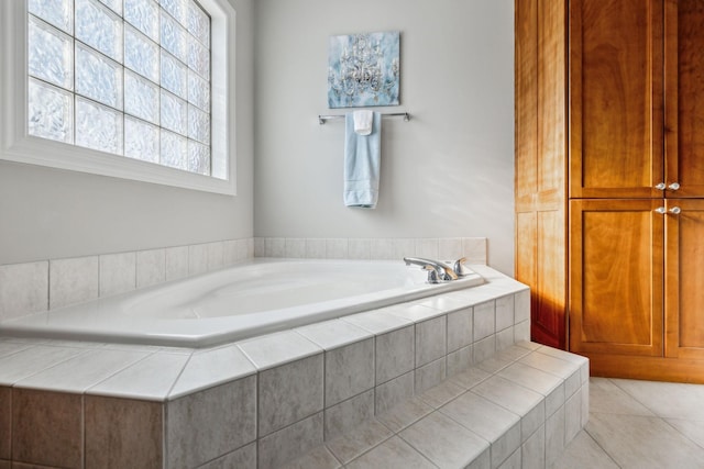 bathroom with tile patterned floors and tiled tub