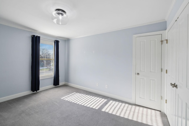 carpeted spare room with crown molding