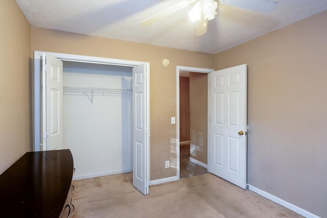 unfurnished bedroom with light carpet, a closet, and ceiling fan