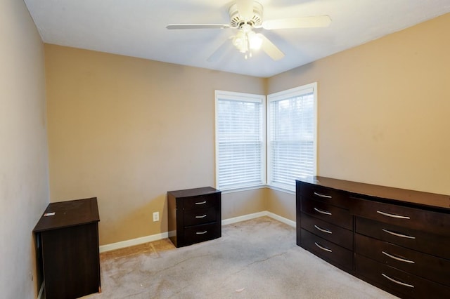 interior space with light colored carpet and ceiling fan