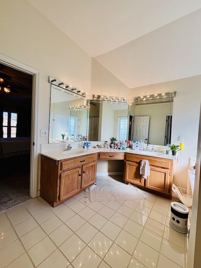 bathroom with tile patterned flooring, lofted ceiling, and vanity