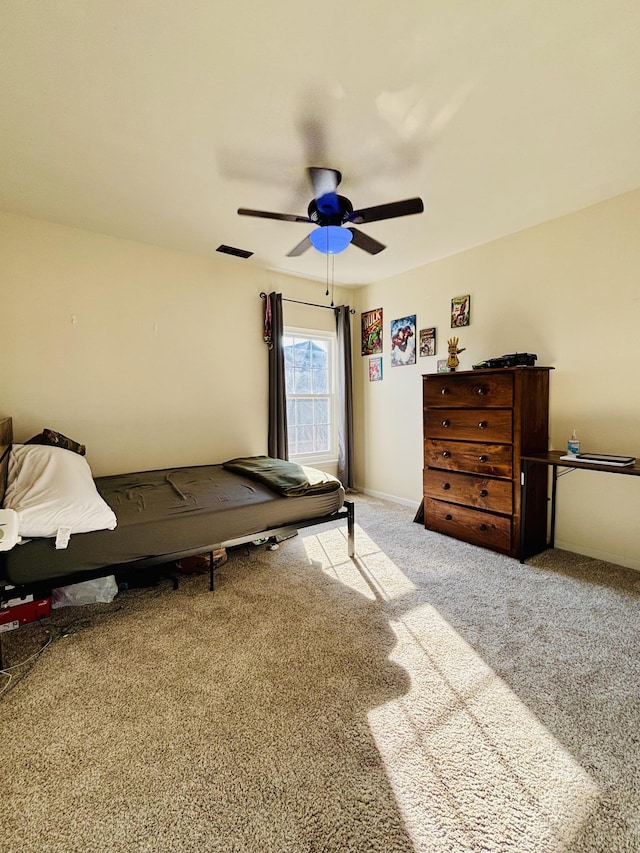 bedroom featuring ceiling fan and carpet