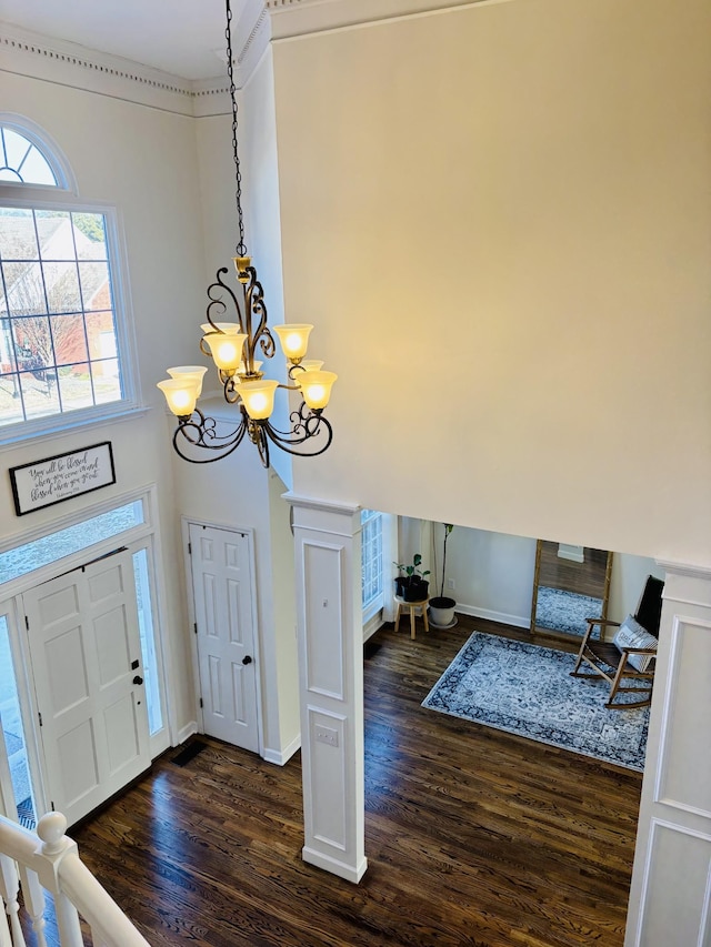 foyer featuring an inviting chandelier and dark hardwood / wood-style floors