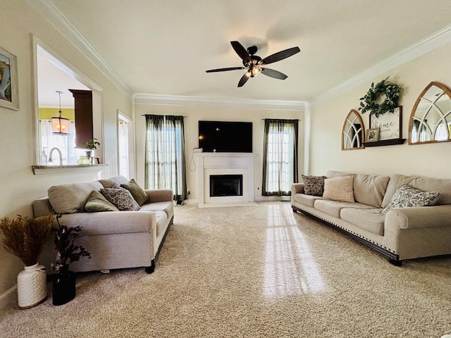 living room featuring ornamental molding, ceiling fan, and a wealth of natural light