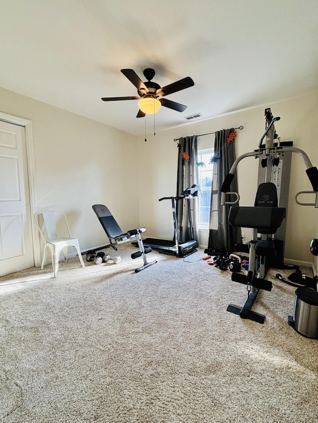 workout area with ceiling fan and carpet flooring