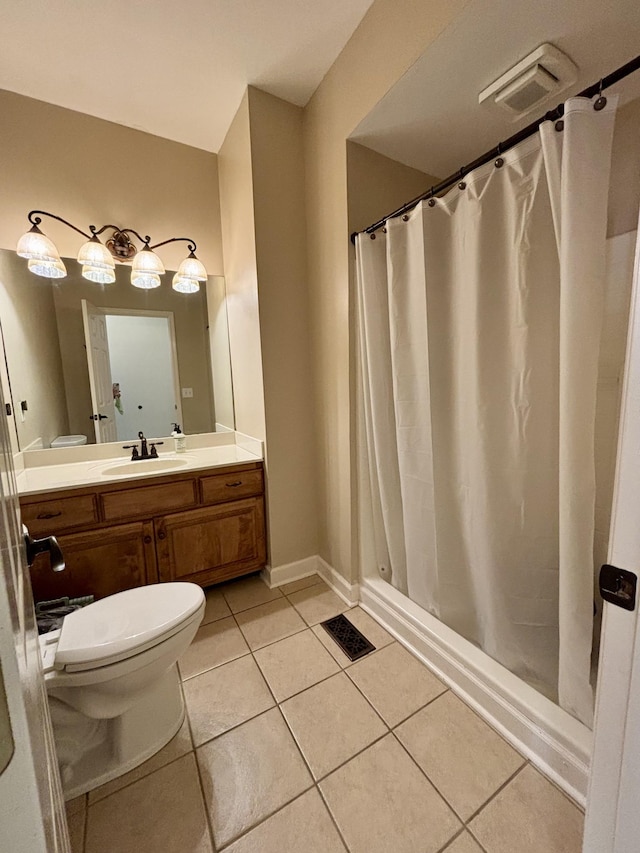 bathroom featuring toilet, tile patterned floors, and vanity