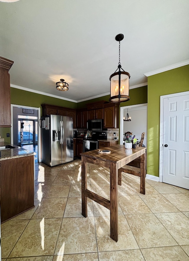 kitchen with pendant lighting, stainless steel appliances, ornamental molding, light tile patterned flooring, and dark brown cabinets