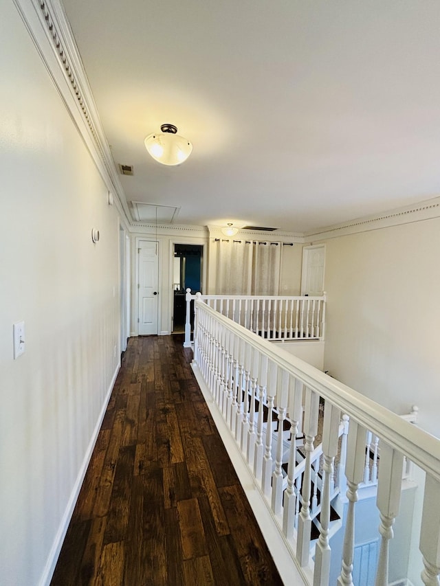 hallway with hardwood / wood-style floors and crown molding