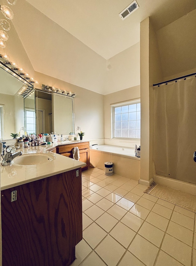 bathroom with lofted ceiling, vanity, tile patterned floors, and a bathing tub