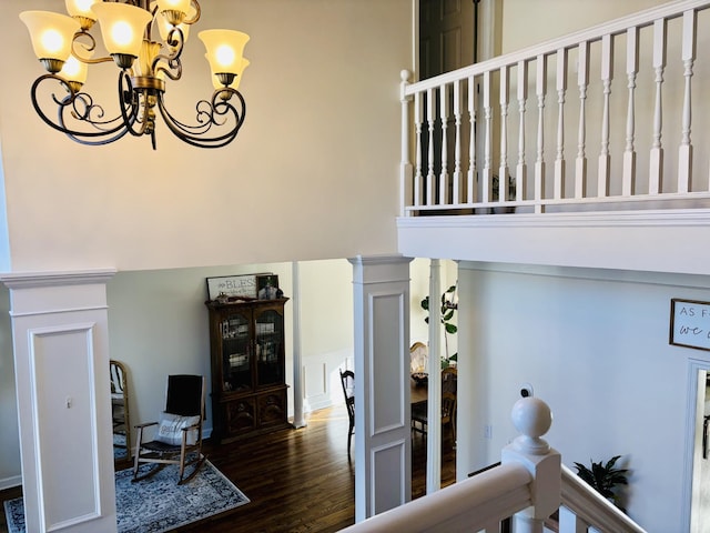 stairway featuring hardwood / wood-style floors and a chandelier