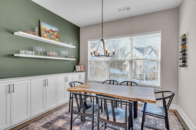 dining room featuring hardwood / wood-style flooring and an inviting chandelier