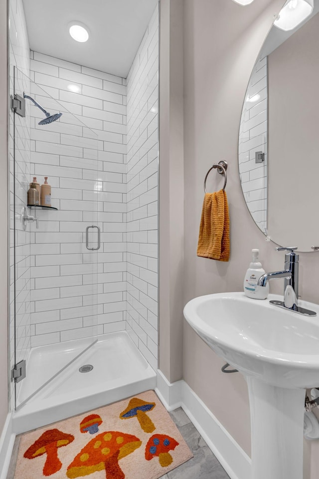 bathroom featuring sink and a tile shower