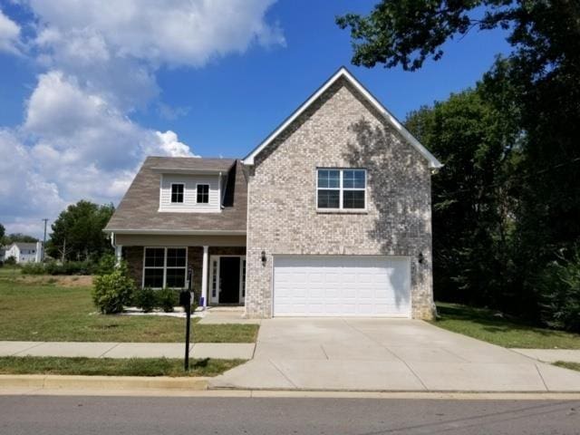 view of front facade featuring a garage and a front lawn