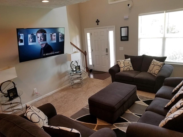 living room with a textured ceiling and light carpet