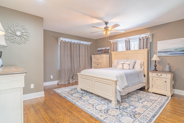 bedroom with ceiling fan and light hardwood / wood-style floors