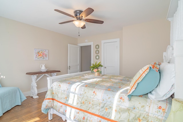 bedroom with ceiling fan and hardwood / wood-style floors