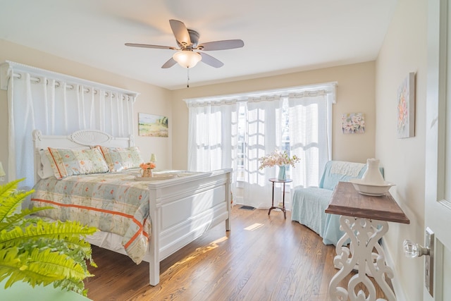 bedroom with ceiling fan and hardwood / wood-style flooring