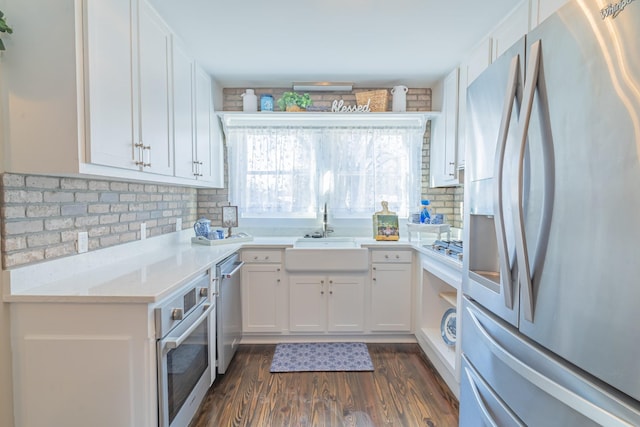 kitchen with dark hardwood / wood-style floors, stainless steel appliances, white cabinets, and sink