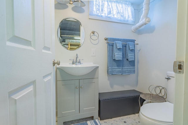 bathroom with toilet and vanity