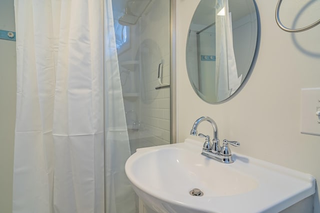 bathroom featuring a shower and sink