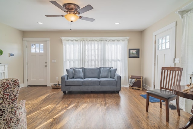 living room with ceiling fan and dark hardwood / wood-style floors