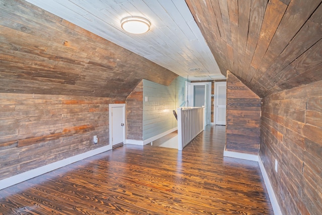 bonus room featuring vaulted ceiling, wood ceiling, and wood walls