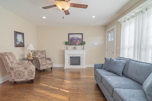 living room with ceiling fan and dark hardwood / wood-style flooring