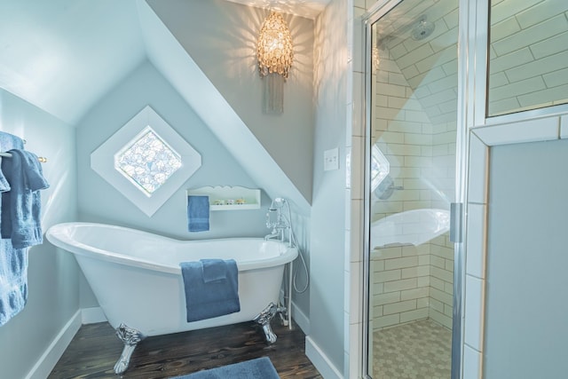 bathroom featuring plus walk in shower, vaulted ceiling, and hardwood / wood-style floors