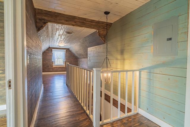 hallway with wooden walls, wooden ceiling, dark hardwood / wood-style floors, vaulted ceiling, and electric panel