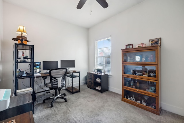 carpeted office featuring ceiling fan