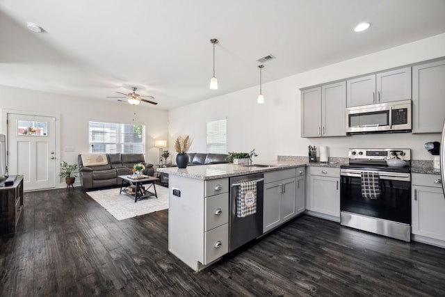 kitchen with kitchen peninsula, stainless steel appliances, gray cabinetry, and hanging light fixtures