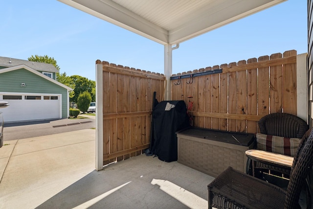 view of patio with a garage and area for grilling