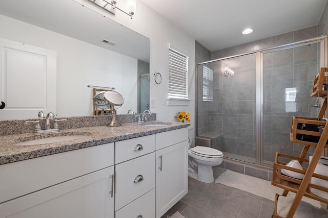 bathroom with toilet, vanity, tile patterned flooring, and walk in shower