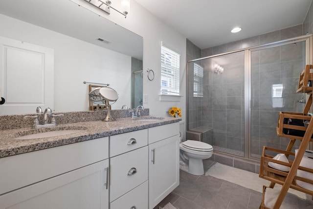 bathroom with toilet, tile patterned floors, walk in shower, and vanity