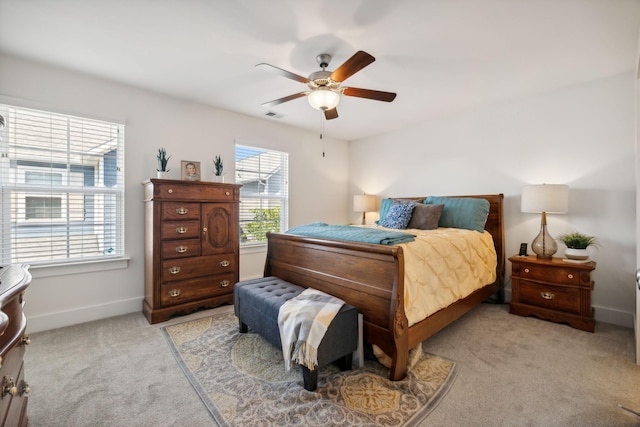 bedroom with ceiling fan and light colored carpet