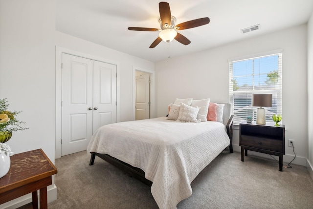 carpeted bedroom with ceiling fan and a closet