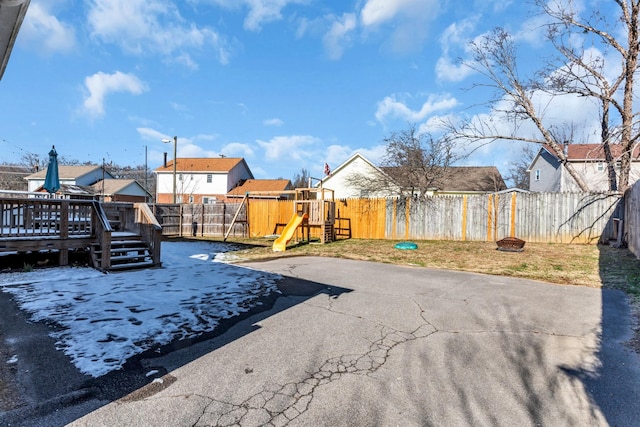 view of yard with a deck, a playground, and a patio area