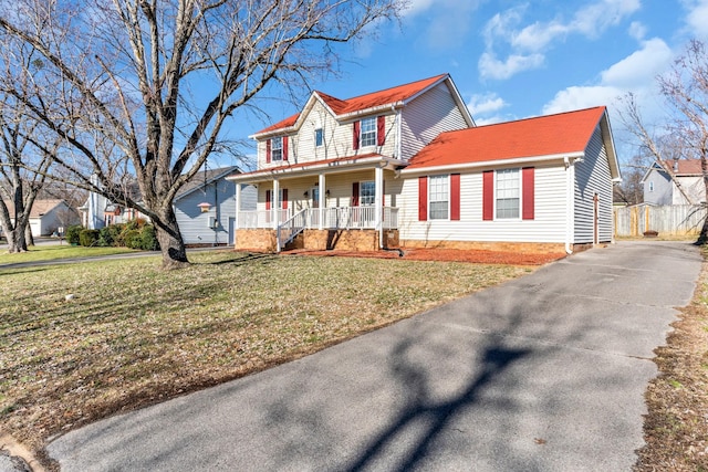 front facade with a front yard and covered porch