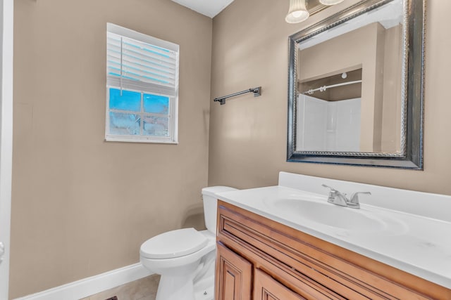 bathroom with toilet, a shower, vanity, and tile patterned floors