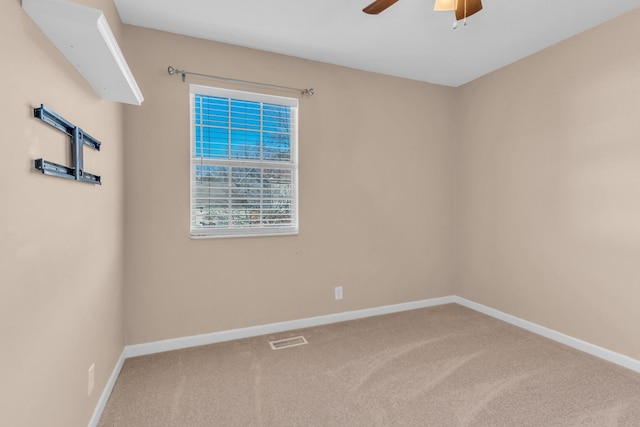 unfurnished room with ceiling fan and carpet flooring