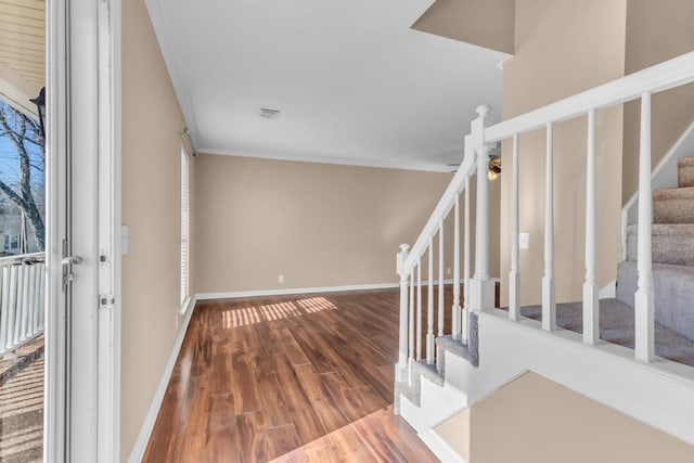 entryway with ceiling fan, hardwood / wood-style flooring, and crown molding