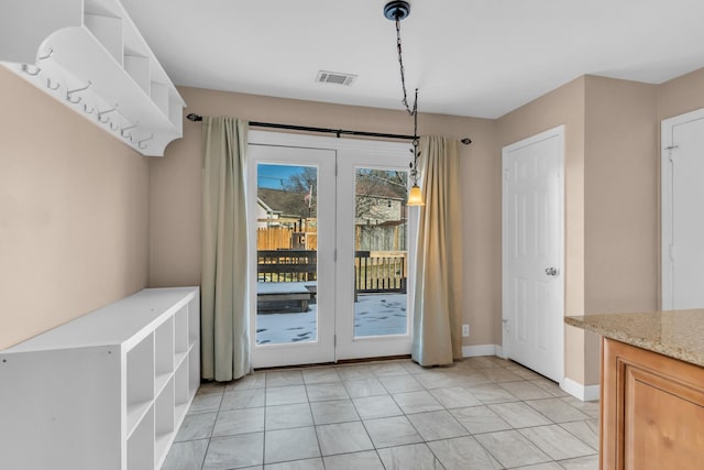 doorway to outside featuring light tile patterned floors