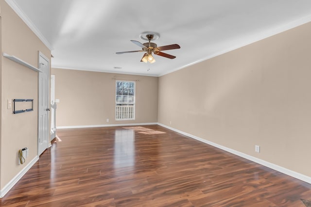 spare room with dark hardwood / wood-style flooring, ornamental molding, and ceiling fan