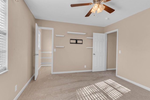 unfurnished bedroom featuring ceiling fan and light carpet