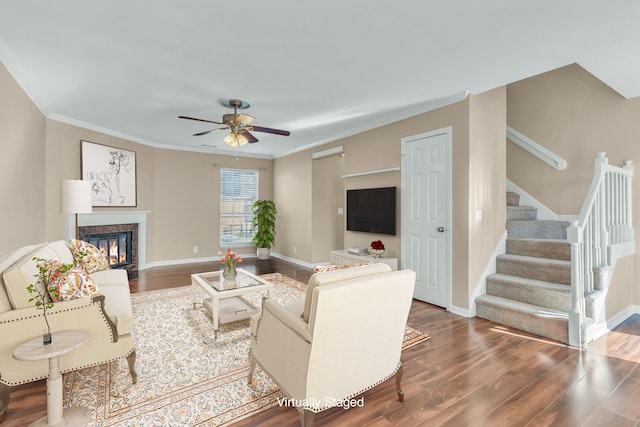 living room featuring ceiling fan, crown molding, and dark hardwood / wood-style floors