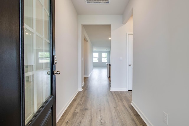 corridor with light wood-type flooring